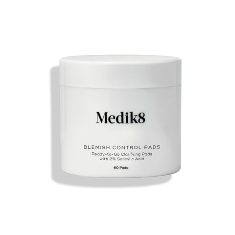 Medik8 Blemish Control Pads™ in a white container holds 60 clarifying pads with 2% salicylic acid to prevent breakouts effectively.
