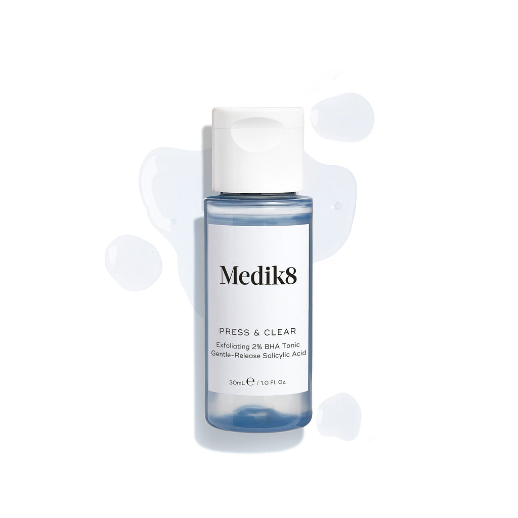 A Medik8 Press & Clear™ (Travel Size) bottle with 2% gentle release salicylic acid sits against a plain white background, ideal for blemish-prone skin.