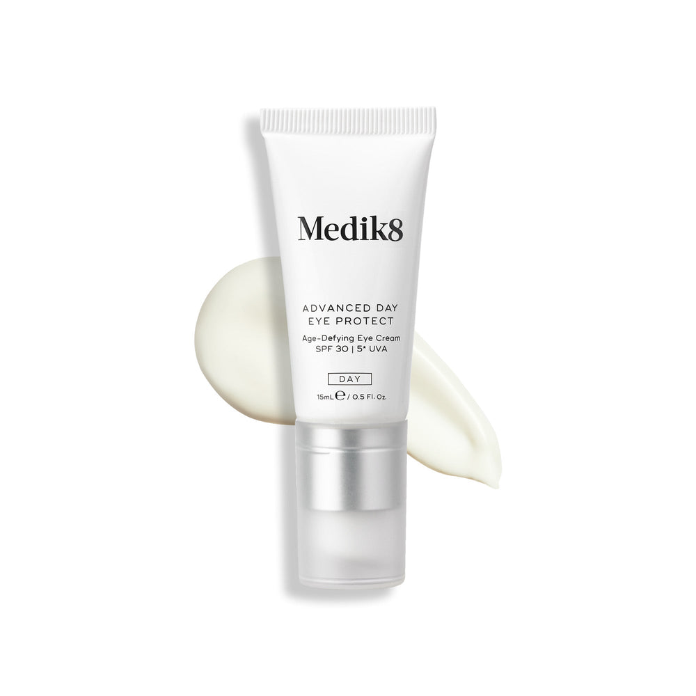 Tube of Medik8 Advanced Day Eye Protect™ with a product smear beside it, providing wrinkle prevention and SPF 30 eye protection.
