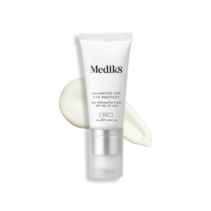 Tube of Medik8 Advanced Day Eye Protect™ with a product smear beside it, providing wrinkle prevention and SPF 30 eye protection.