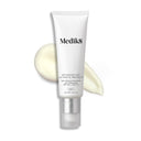 A white tube of Medik8's Advanced Day Ultimate Protect™ moisturizer SPF 50+, featuring DNA repair enzymes, sits elegantly against a swirled cream backdrop, promising a non-comedogenic finish.