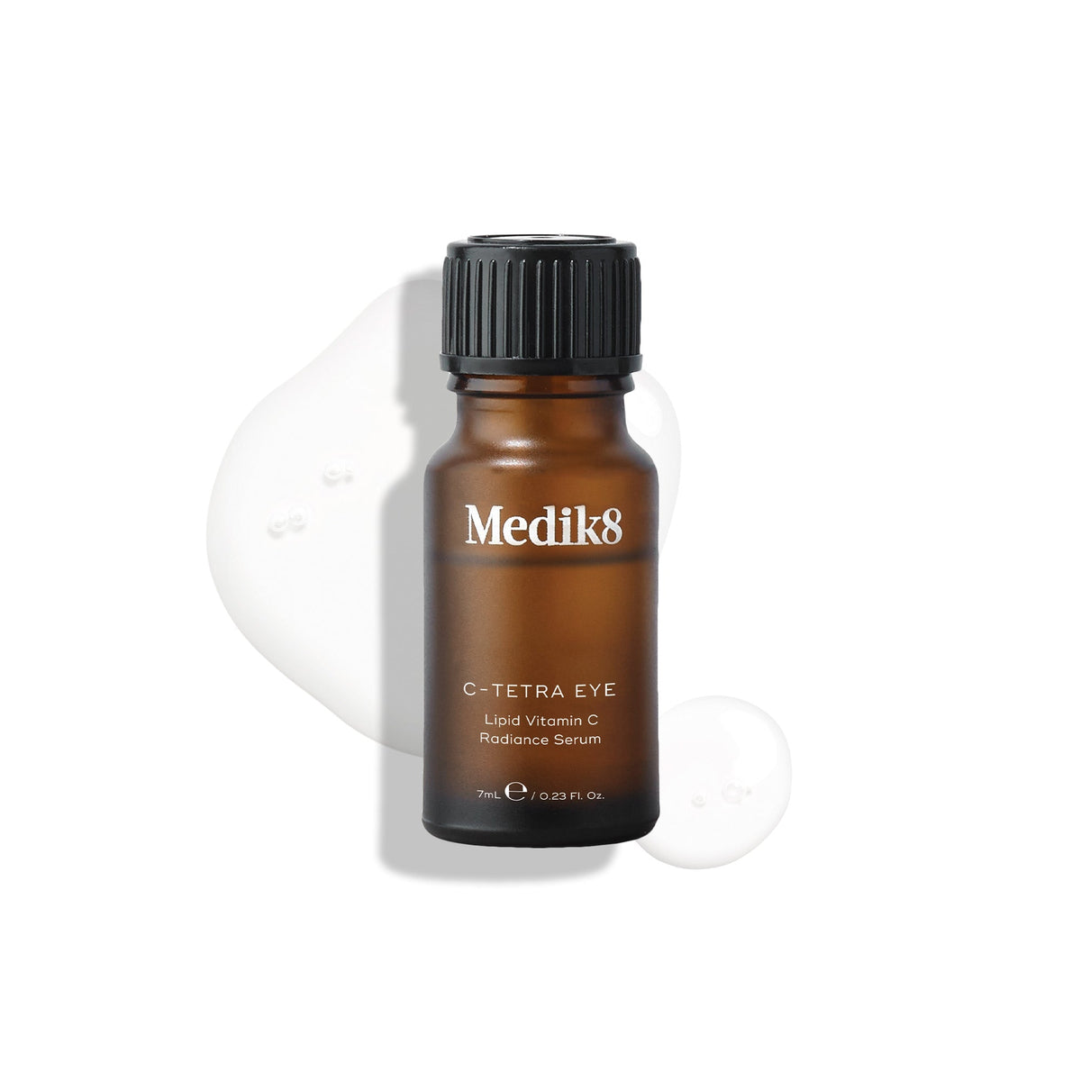A brown bottle labeled "C-Tetra® Eye" from Medik8, topped with a black cap, stands against a white background. Its contents—a potent vitamin C serum for fine lines and wrinkles—are spilled underneath.