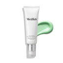 A tube of Medik8's Calmwise™ Colour Correct moisturizer, a redness-neutralizing formula with bakuchiol, sits elegantly beside a green product smear on a crisp white background.