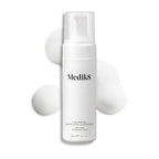 A white Medik8 Calmwise™ Soothing Cleanser bottle, chlorophyll-infused for enhanced care, features a pump top. Nestled amid gentle foam on a pristine white backdrop, it's perfect for soothing compromised skin.