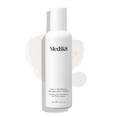 A white bottle of Medik8's Daily Refresh Balancing Toner™ displays black text with a light liquid splash on a white background, making it an ideal daily hydrator for your skin.
