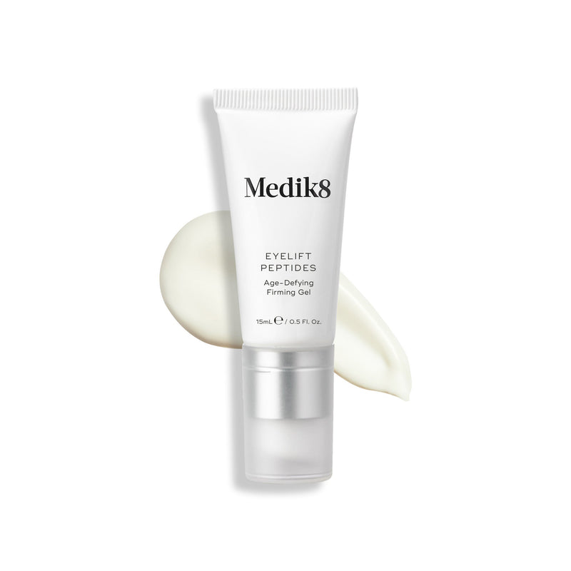 A tube of Medik8's Eyelift™ Peptides, 15ml, rests elegantly on a creamy white smear.