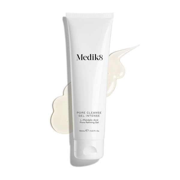 A white tube labeled "Medik8 Pore Cleanse Gel™ Intense" (150ml), featuring L-Mandelic Acid, is set against a white backdrop, with a smear of its AHA/BHA-enriched exfoliating gel cleanser elegantly beside it.