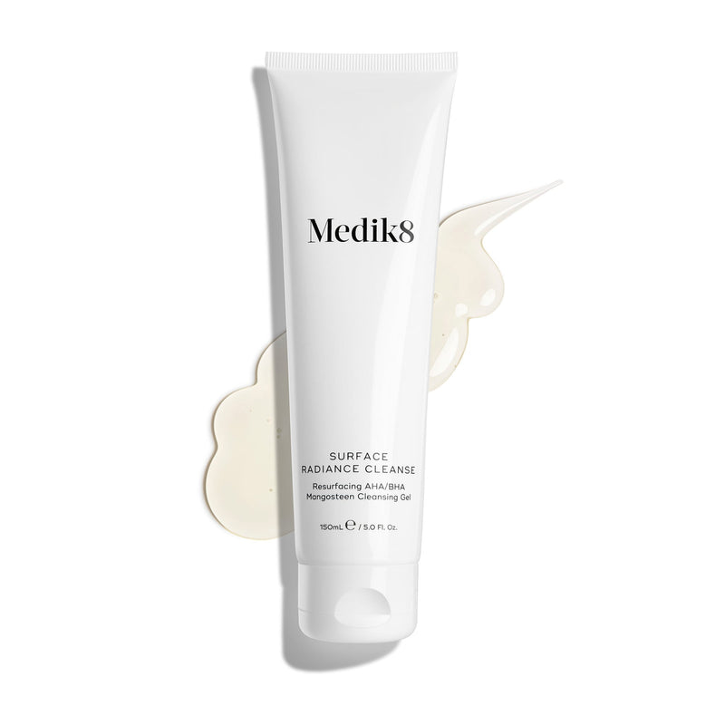 Medik8's Surface Radiance Cleanse™, an exfoliating cleanser with AHA/BHA complex, is shown on a white background with some gel spilled next to the tube.