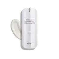 A white bottle of Medik8 r-Retinoate® Day & Night cream, containing retinyl retinoate and vitamin A, comes with a pump dispenser and is pictured next to a swirl of the anti-aging serum.
