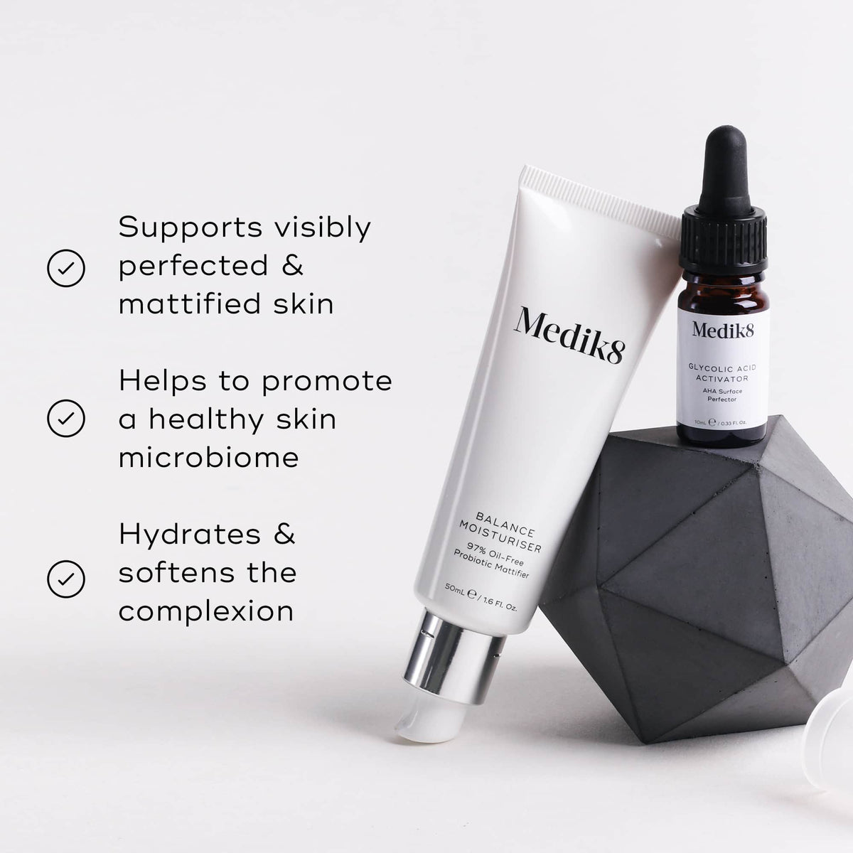 A Medik8 dropper bottle and a Balance Moisturiser™ tube sit beside a geometric object on a light background, highlighting benefits: mattified skin, healthy microbiome, and complexion hydration for an enhanced glow.