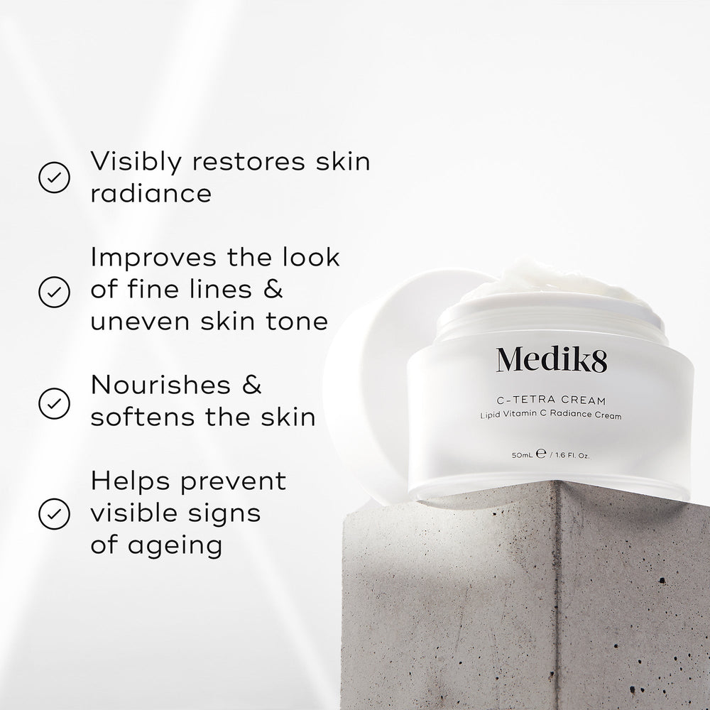The Medik8 C-Tetra® Cream rests on concrete, showcasing its promise to restore skin radiance and improve fine lines. Enriched with vitamin C, it nourishes skin while combating signs of aging.