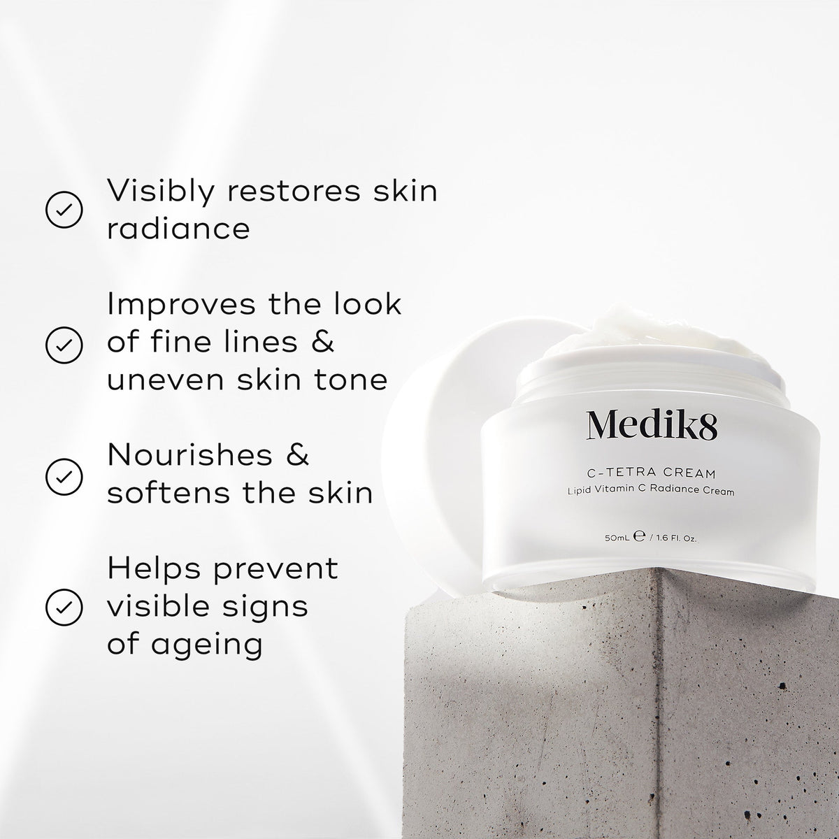 The Medik8 C-Tetra® Cream rests on concrete, showcasing its promise to restore skin radiance and improve fine lines. Enriched with vitamin C, it nourishes skin while combating signs of aging.
