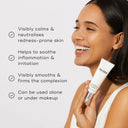A person smiles while holding a Medik8 Calmwise™ Colour Correct. The formula calms redness, soothes irritation, and smooths complexion, perfect for use alone or under makeup.