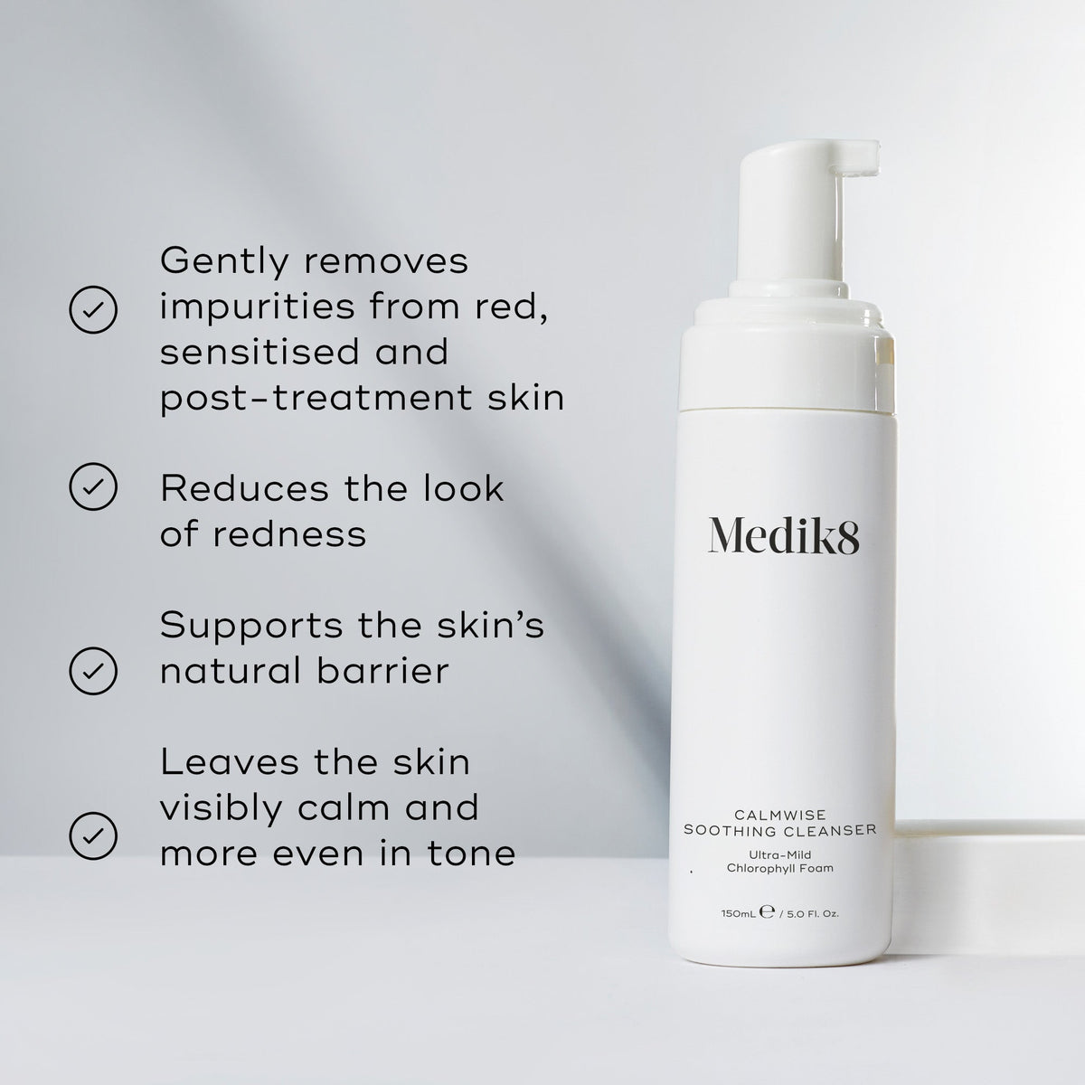 The white bottle of Calmwise™ Soothing Cleanser by Medik8 highlights its benefits for sensitive, red, and compromised skin: it removes impurities, reduces redness with a chlorophyll-infused formula, supports the barrier, and evens skin tone.