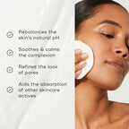 A person applies Medik8's Daily Refresh Balancing Toner™ with a cotton pad to rebalance pH, soothe complexion, refine pores, and enhance absorption of skincare actives for effective skin hydration.