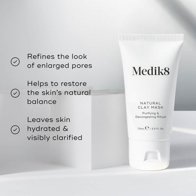 A tube of Medik8 Natural Clay Mask™, with bentonite and kaolin clay, sits on a white surface. Text emphasizes its benefits: refining pores, restoring skin balance, and hydrating the skin.