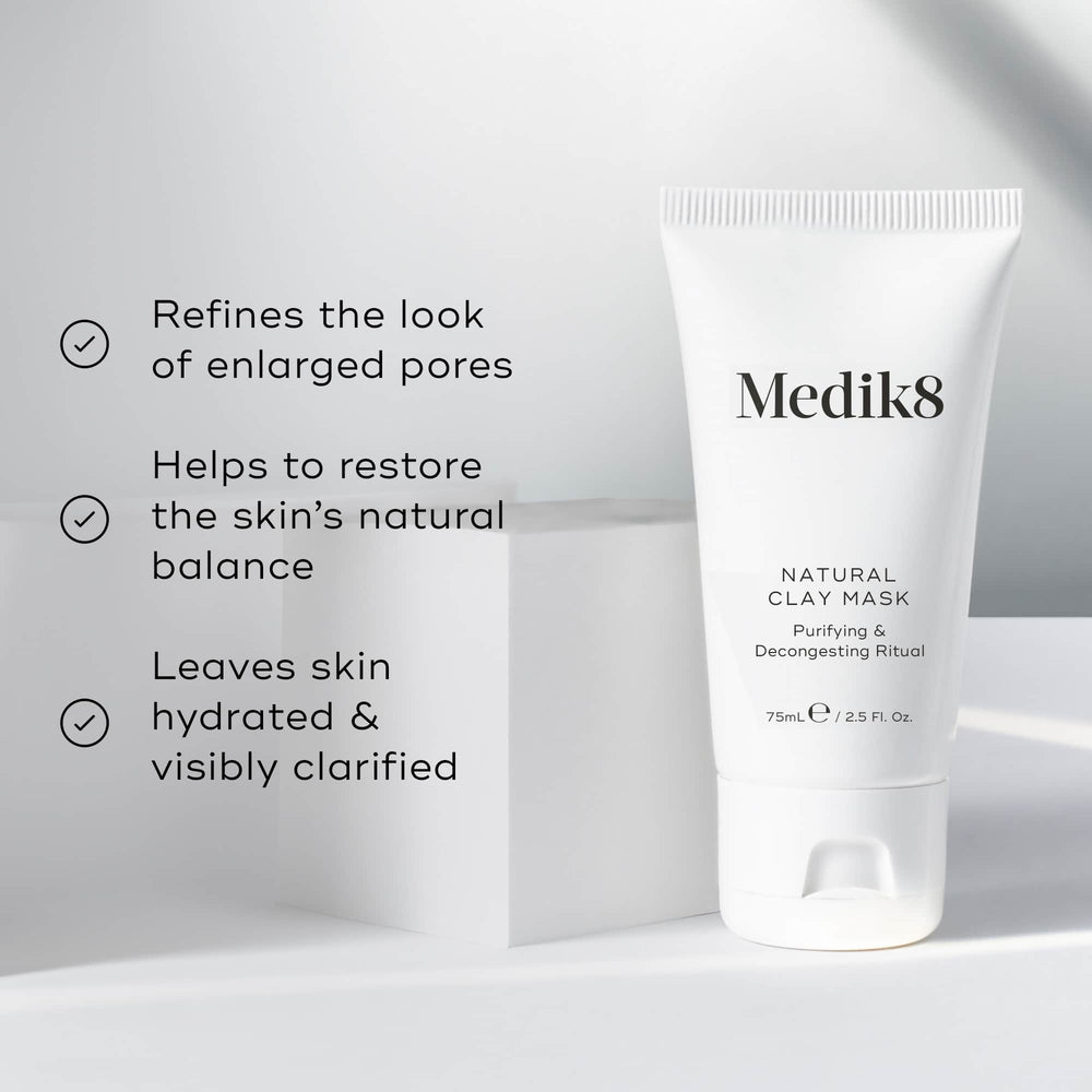 A tube of Medik8 Natural Clay Mask™, with bentonite and kaolin clay, sits on a white surface. Text emphasizes its benefits: refining pores, restoring skin balance, and hydrating the skin.