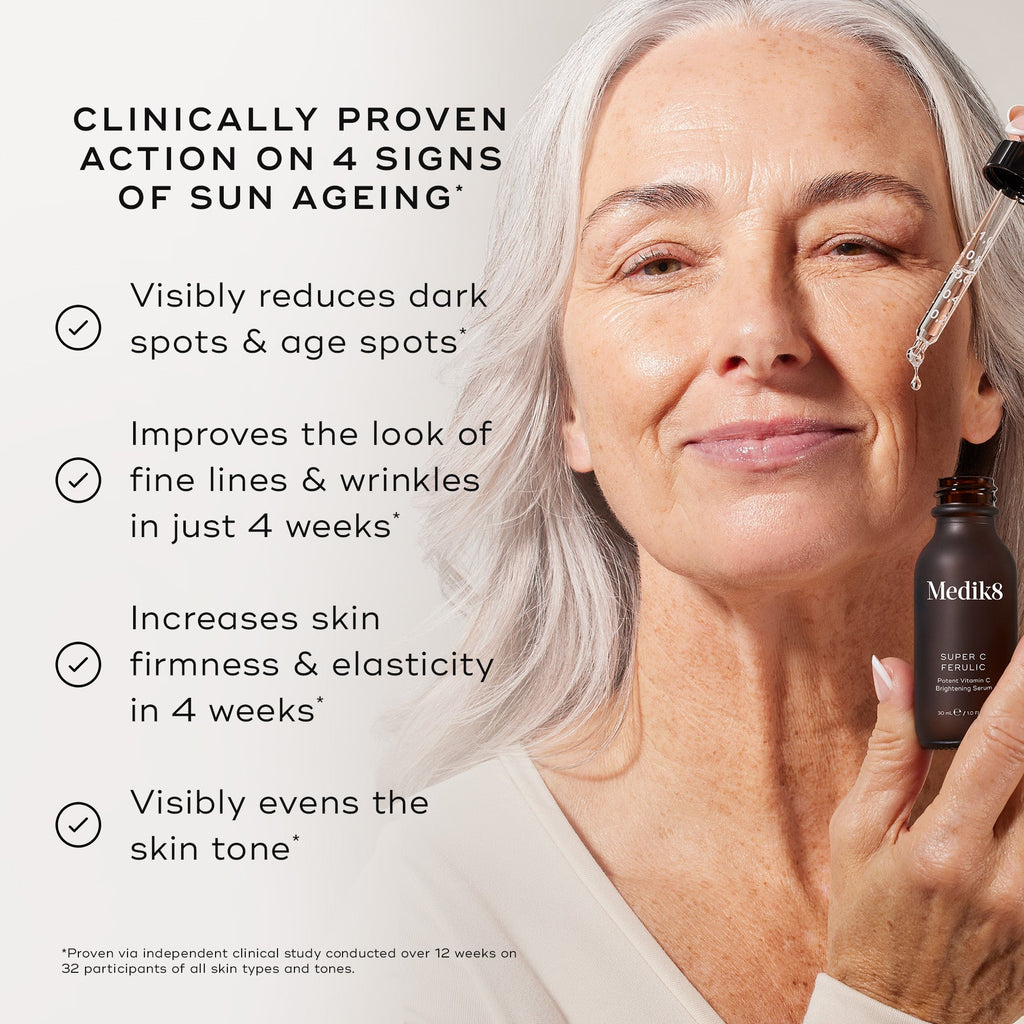 An older woman uses Medik8's Super C Ferulic™ serum for sun aging, benefiting from reduced dark spots, improved fine lines, increased firmness, and evened skin tone for radiant, youthful-looking skin.