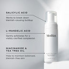 A bottle of Clarifying Foam™ by Medik8 highlights ingredients like salicylic acid (BHA), L-mandelic acid (AHA), niacinamide, and tea tree oil, showcasing their skin-revitalizing benefits.