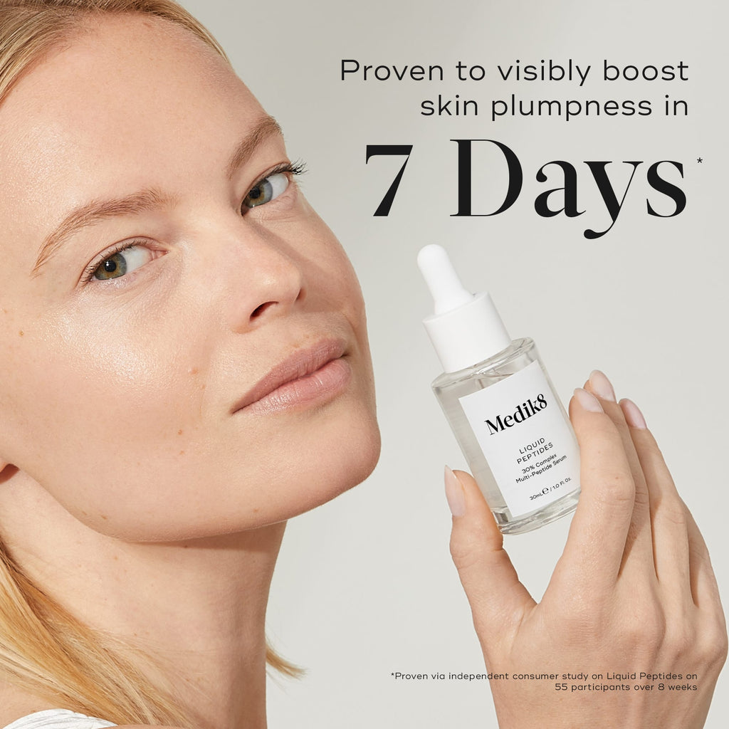 A person holds a Medik8 Liquid Peptides™ (Travel Size) bottle next to their face with text stating, "Proven to boost skin plumpness and smooth lines in 7 days.
