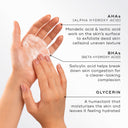 Hands applying Surface Radiance Cleanse™ (Travel Size) by Medik8, featuring an AHA/BHA complex for exfoliation and congestion reduction, plus Glycerin for deep hydration.