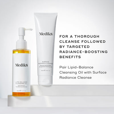 Medik8's Lipid-Balance Cleansing Oil™ and Surface Radiance Cleanse are elegantly arranged on a white backdrop, highlighting their makeup removal and anti-pollution benefits. Transform your skincare routine with these radiance-boosting products.