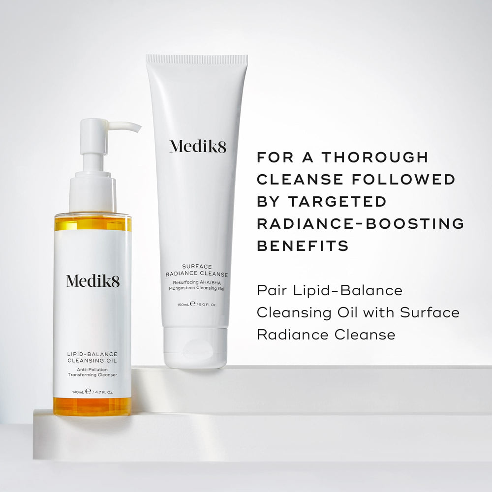 Medik8's Lipid-Balance Cleansing Oil™ and Surface Radiance Cleanse are elegantly arranged on a white backdrop, highlighting their makeup removal and anti-pollution benefits. Transform your skincare routine with these radiance-boosting products.