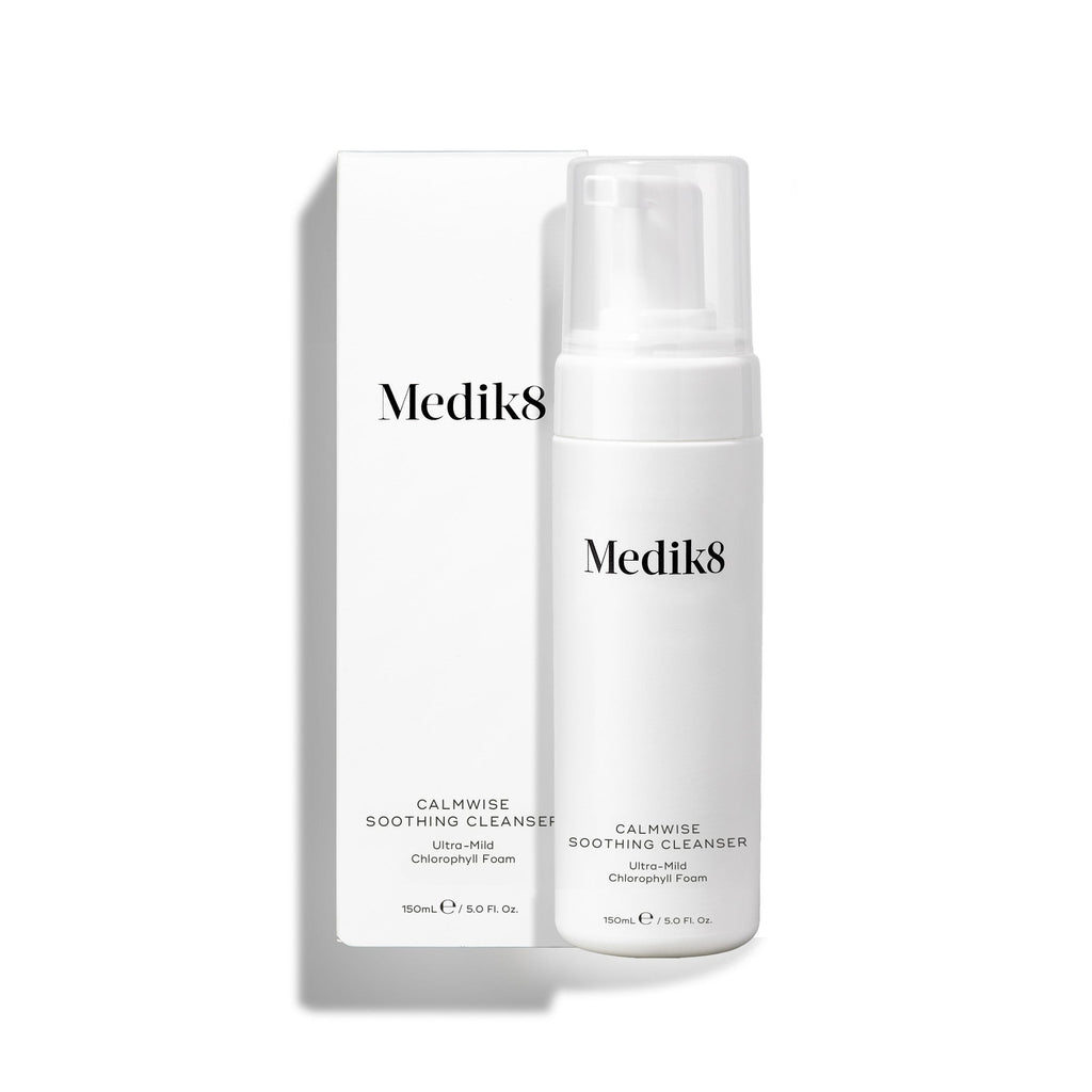 The white bottle of Calmwise™ Soothing Cleanser by Medik8, infused with chlorophyll to soothe compromised skin, comes with a pump dispenser and a matching box. Both feature the brand and product name elegantly in black text.