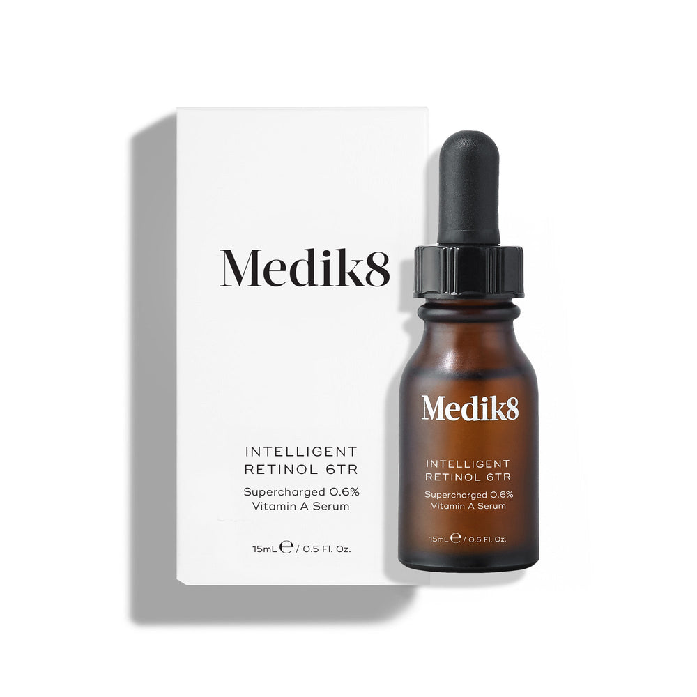 A brown dropper bottle labeled "Medik8 Intelligent Retinol™" in white packaging presents a 0.5 fl oz age-defying vitamin A serum.