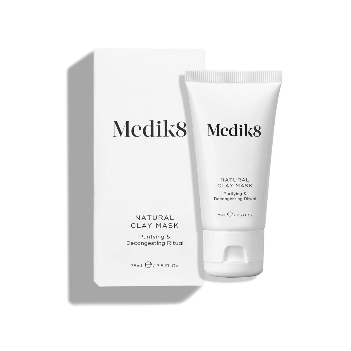 The Natural Clay Mask™ by Medik8, in a 75mL / 2.5 Fl. Oz tube with its sleek white box labeled "Purifying & Decongesting Ritual," uses bentonite and kaolin clay to refine pores.
