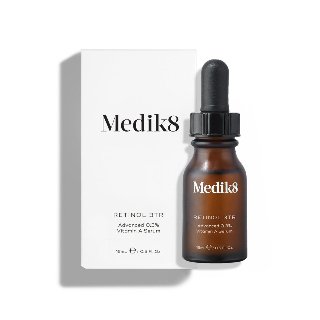 A 15ml Medik8 Retinol 3TR™ serum bottle with a dropper is next to its white packaging, both labeled as Advanced 0.3% Vitamin A Serum. It uses Time Release technology to target fine lines and wrinkles effectively.