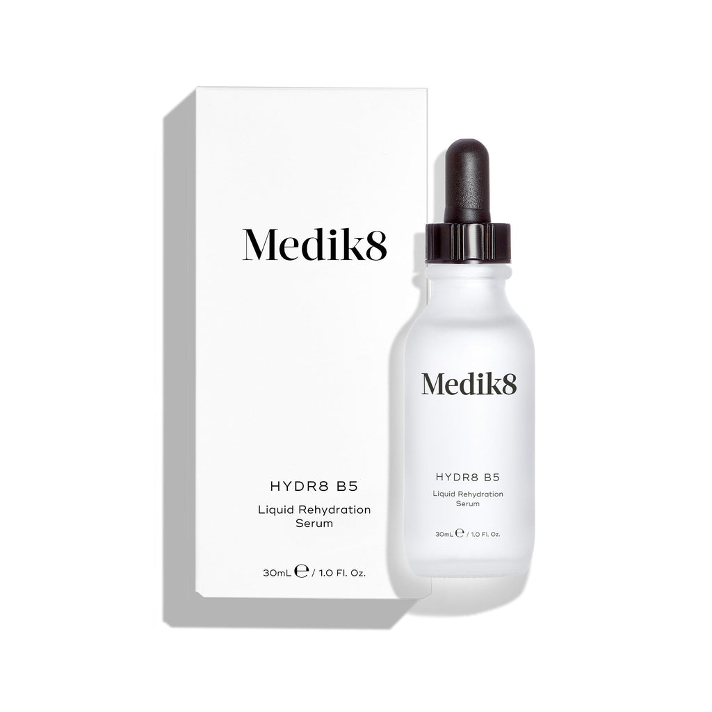 Clear bottle of Medik8's Hydr8 B5™ Serum, enriched with hyaluronic acid for skin hydration and fine line reduction, alongside a dropper and its sleek white box. Label text is black.