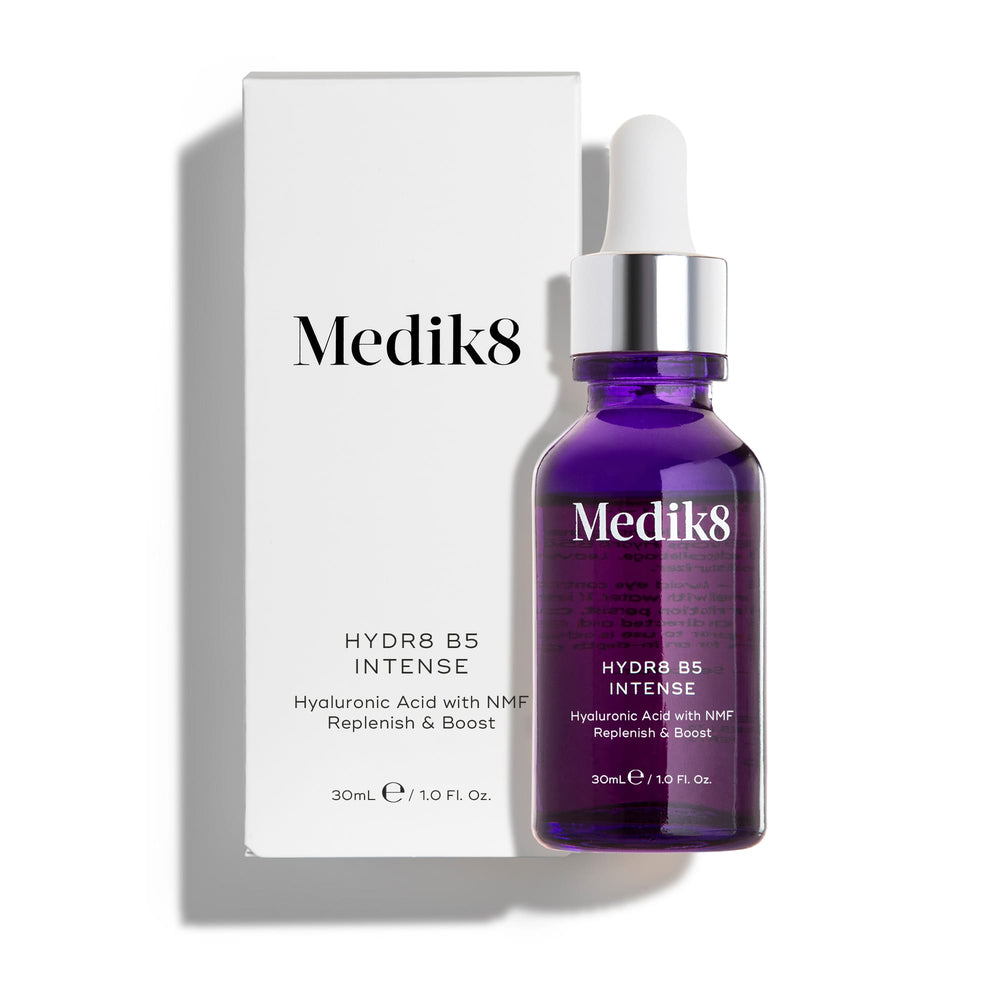 A purple dropper bottle, labeled "Hydr8 B5™ Intense" by Medik8, stands next to its white box, describing the hyaluronic acid serum as packed with NMF for skin rehydration and a boost, along with superfood antioxidants benefits.
