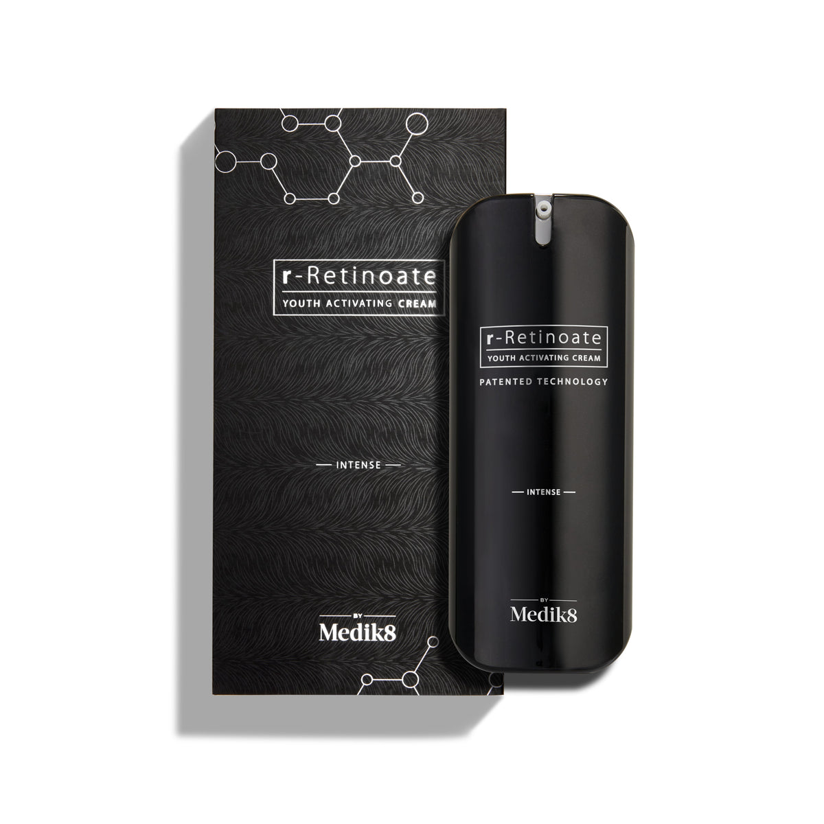A sleek black bottle of Medik8's r-Retinoate® Intense, enriched with Vitamin A for effective wrinkle reduction, sits beside its matching box adorned with a molecular pattern and labeled "Patented Technology.