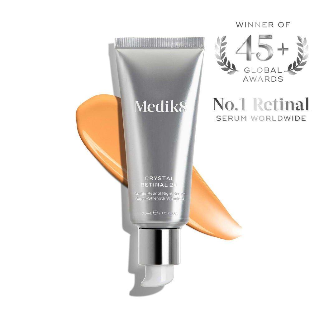 A silver tube of Medik8 Crystal Retinal® vitamin A night serum with an orange smear, labeled the world’s No.1 anti-ageing face serum and winner of 45+ global awards.