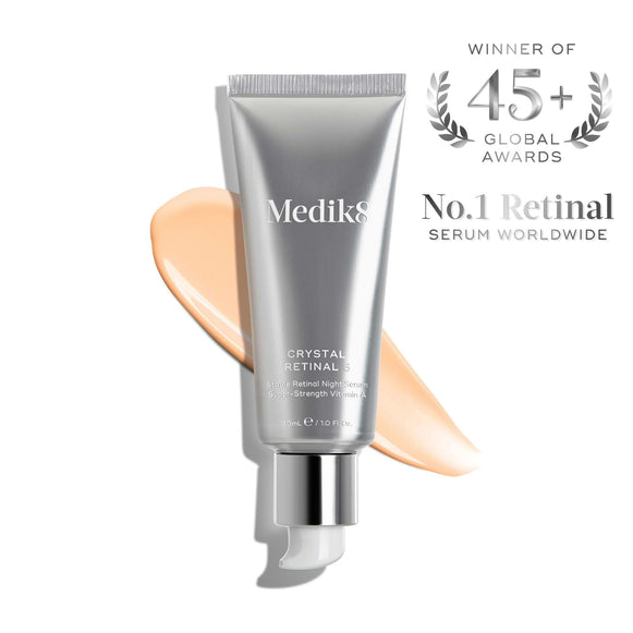 Medik8 Crystal Retinal® anti-aging serum, shown with a peach cream smear, is the No.1 retinal serum worldwide and has won over 45 global awards.-1