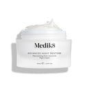 A 50mL jar of Medik8's Advanced Night Restore™, with the lid off, reveals its ceramide-rich formula. This rejuvenating night cream highlights a luxurious white texture and visible plumping effects.