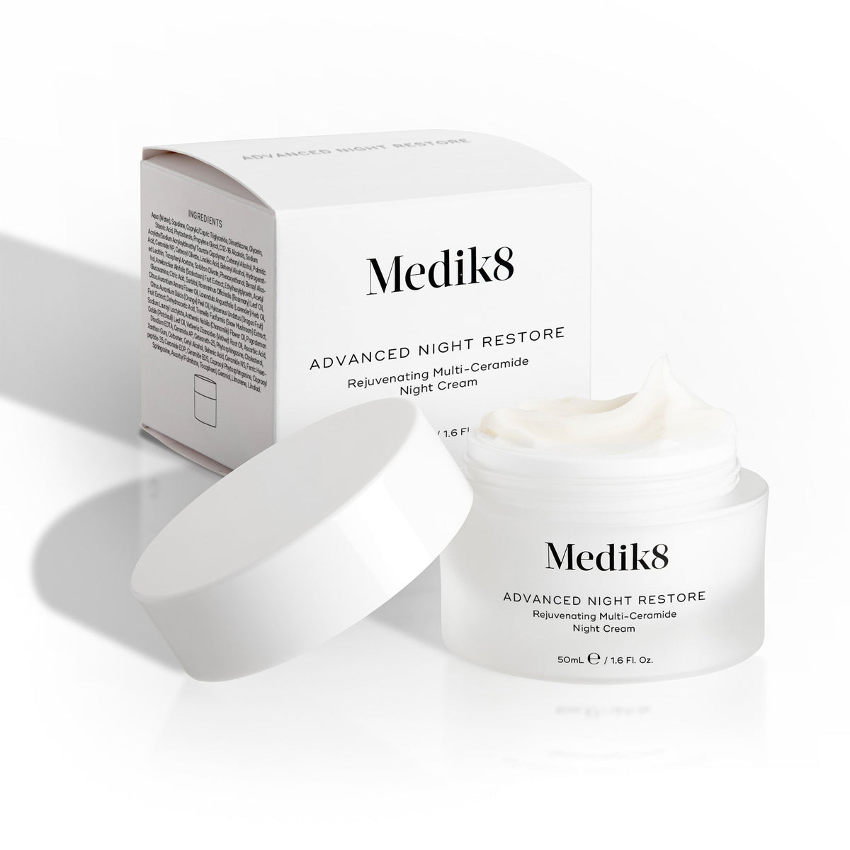 Open jar of Medik8's Advanced Night Restore™ night cream, featuring a ceramide-rich formula for visible plumping, with the box in the background.