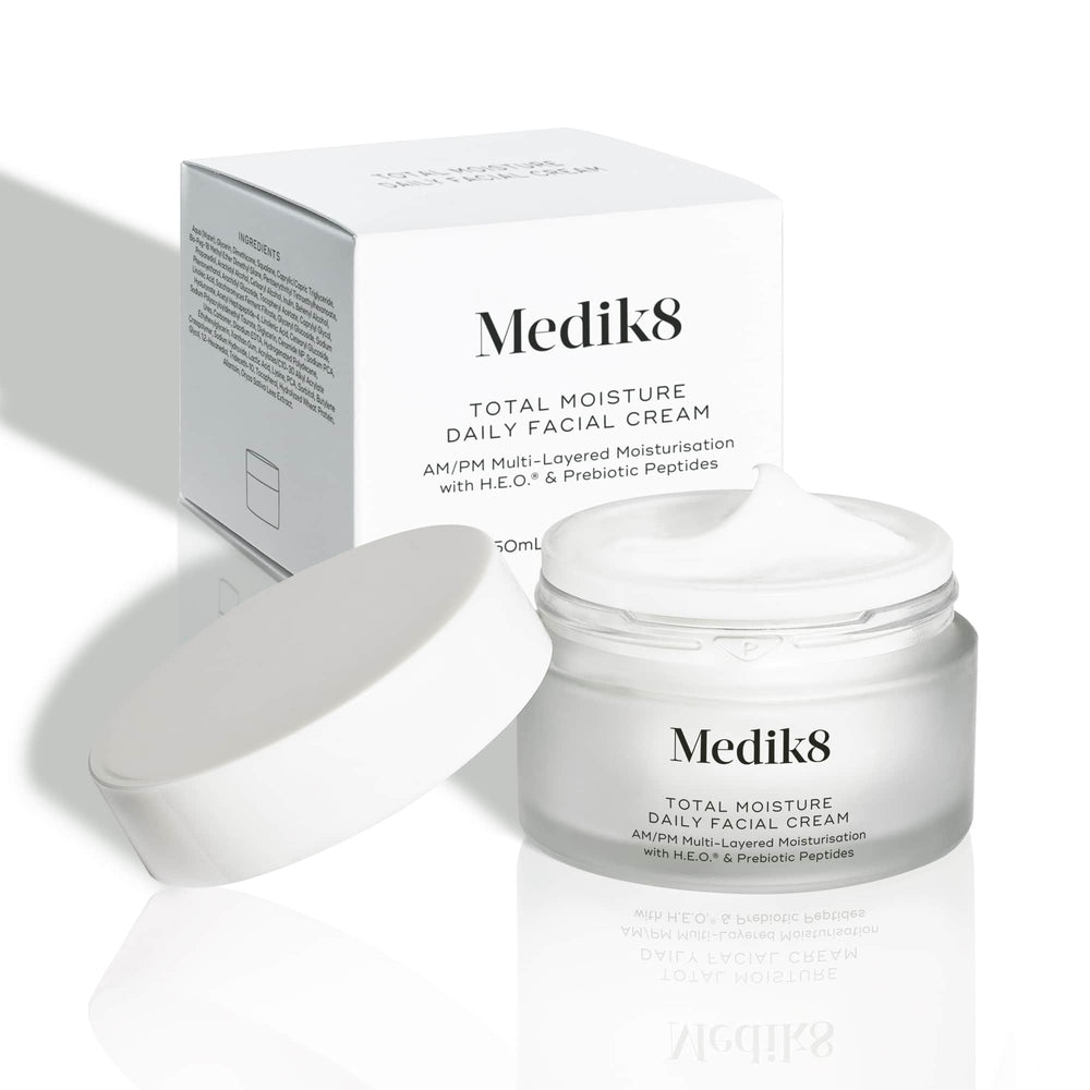 The Medik8 Total Moisture Daily Facial Cream™ is shown with its box and open jar, highlighting its microbiome support for deeply moisturized skin.