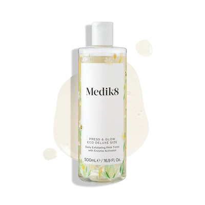 A 500mL bottle of Medik8 Press & Glow® daily exfoliating PHA tonic, enriched with enzyme activator and polyhydroxy acid, is shown on a white background with light liquid splashes—ideal for achieving glowing skin.
