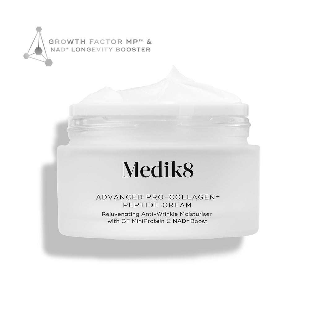 A white jar labeled "Advanced Pro-Collagen+ Peptide Cream" by Medik8 Cyprus, filled with white cream. Highlights include growth factors, NAD+ longevity booster, and anti-aging benefits for firmer skin.