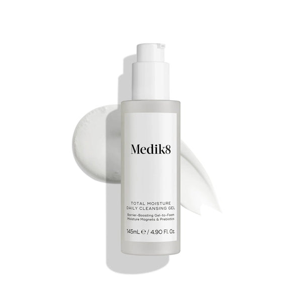 A 145ml bottle of Medik8 Cyprus Total Moisture Daily Cleansing Gel with white gel smears behind it on a white background, featuring a hydration-focused formula to support the skin barrier.