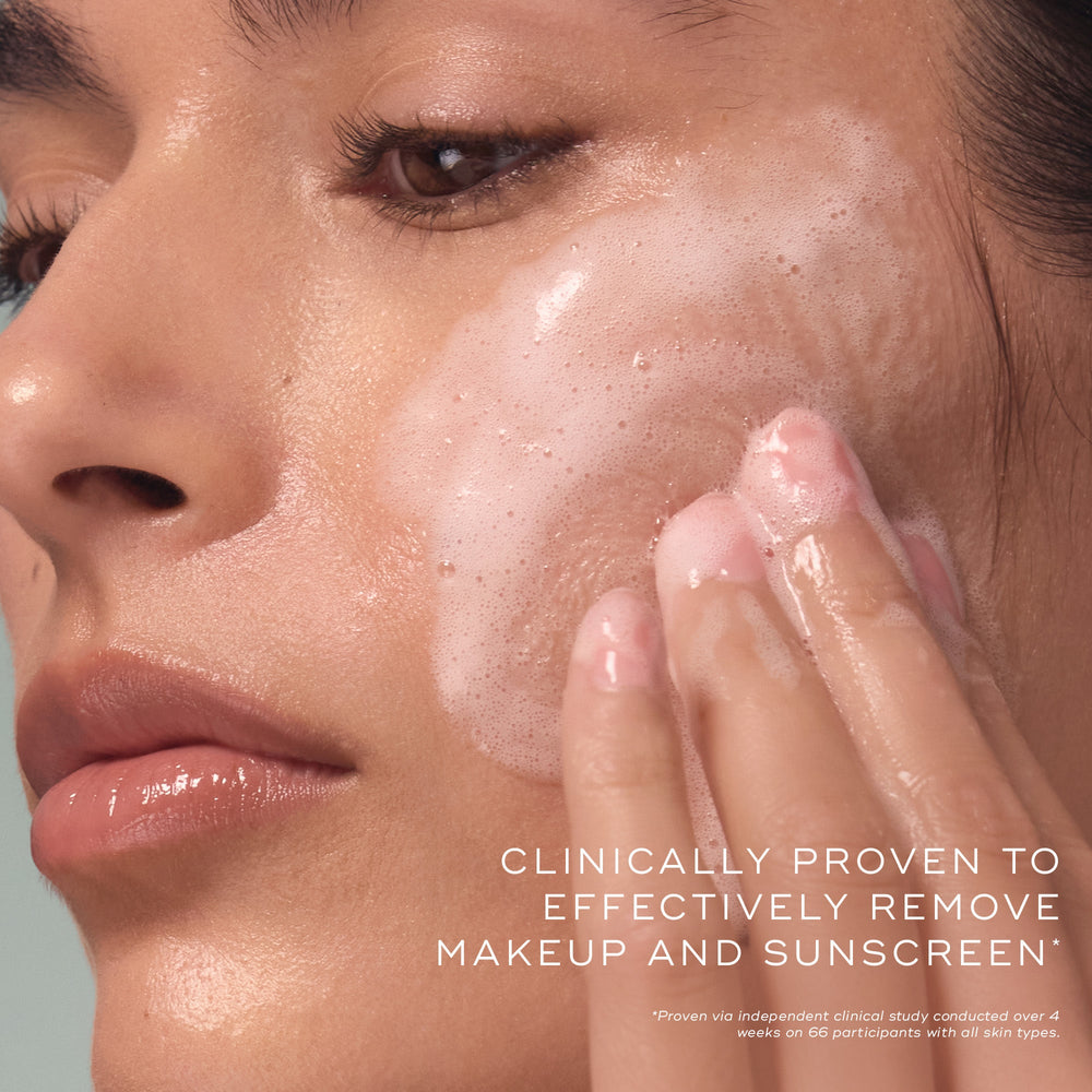 A person applies Total Moisture Daily Cleansing Gel by Medik8 Cyprus to their cheek. Text on the image reads, "Clinically proven hydration cleansing gel removes makeup and sunscreen effectively.