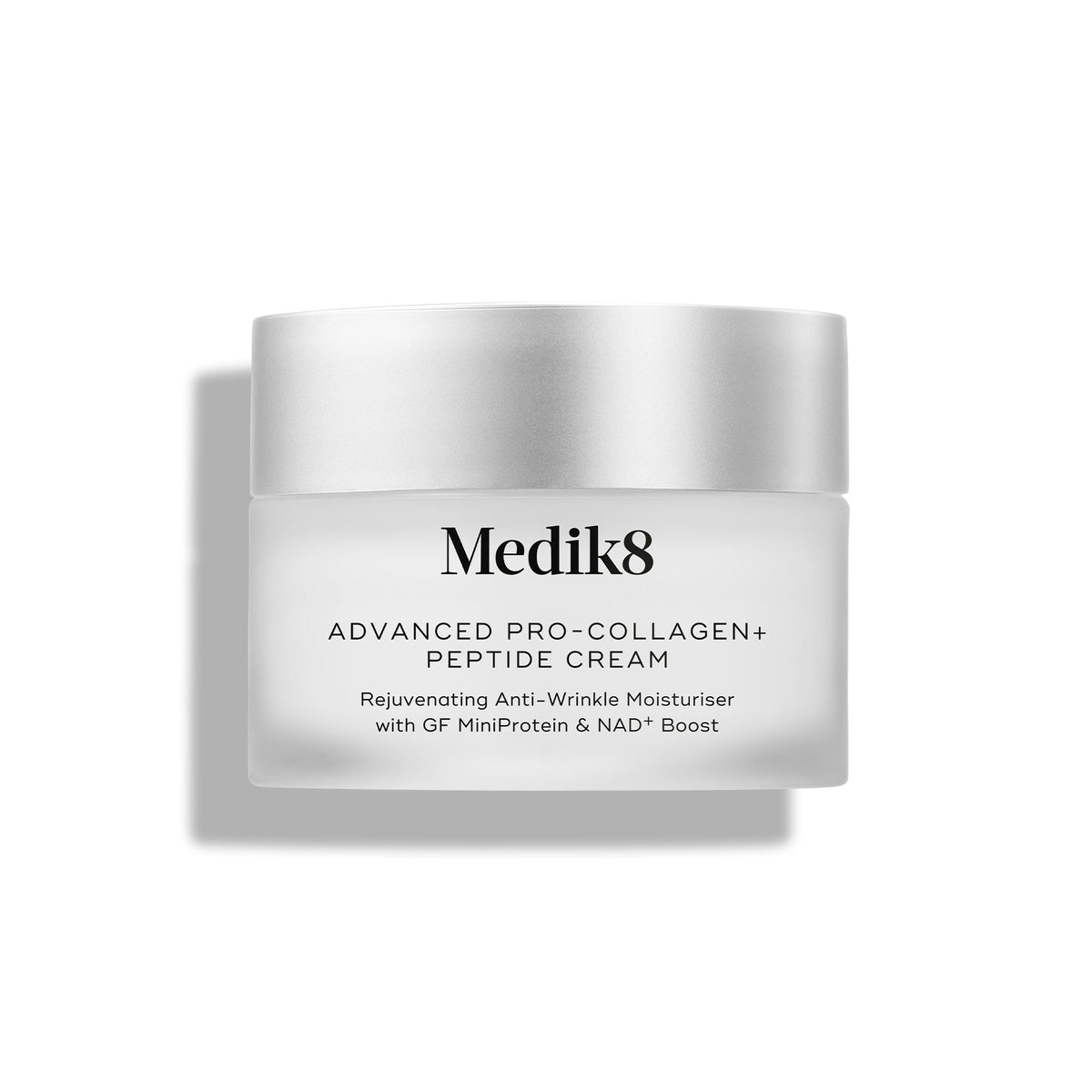A travel-size jar of Medik8 Cyprus Advanced Pro-Collagen+ Peptide Cream with a silver lid, labeled as an anti-wrinkle collagen cream supporting skin firmness with GF MiniProtein and NAD+ boost.