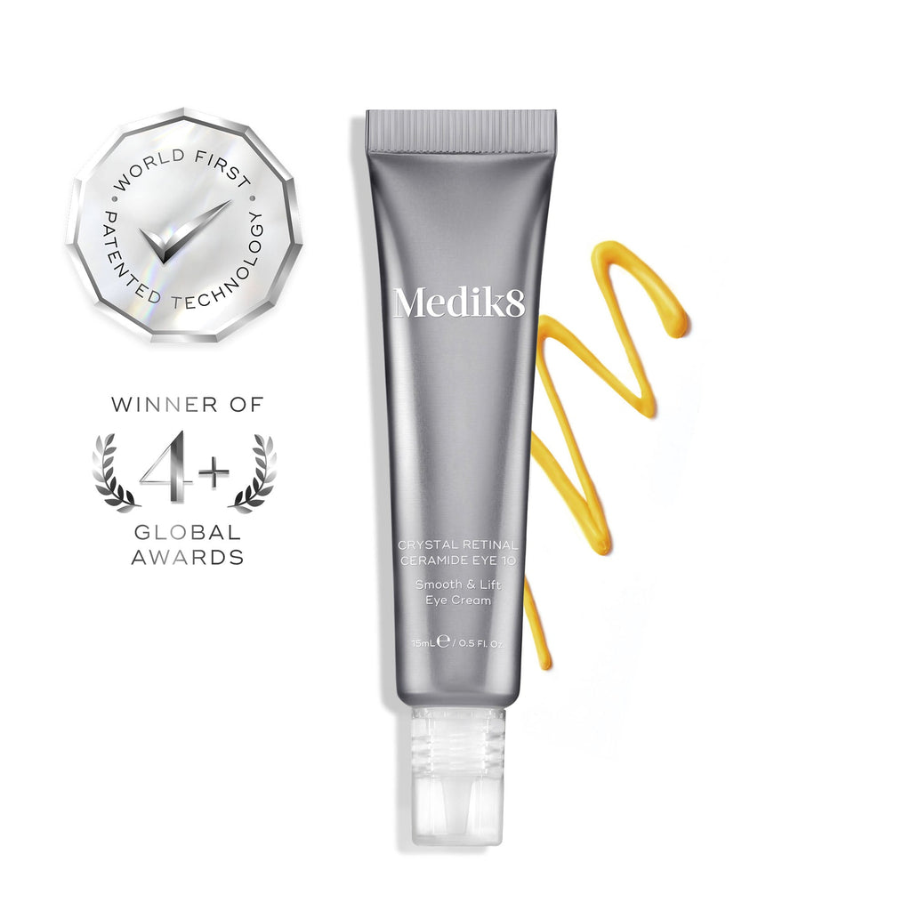 A silver tube of Medik8 Crystal Retinal® Ceramide Eye with a yellow cream swatch, award icons, and “WORLD FIRST PATENTED TECHNOLOGY” plus “WINNER OF 4+ GLOBAL AWARDS” highlights this anti-aging eye treatment for dark circles.