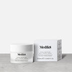 A jar and box of Medik8 Total Moisture Daily Facial Cream™ are displayed on a light gray surface, highlighting daily moisturizing benefits and skin barrier support against a plain background.