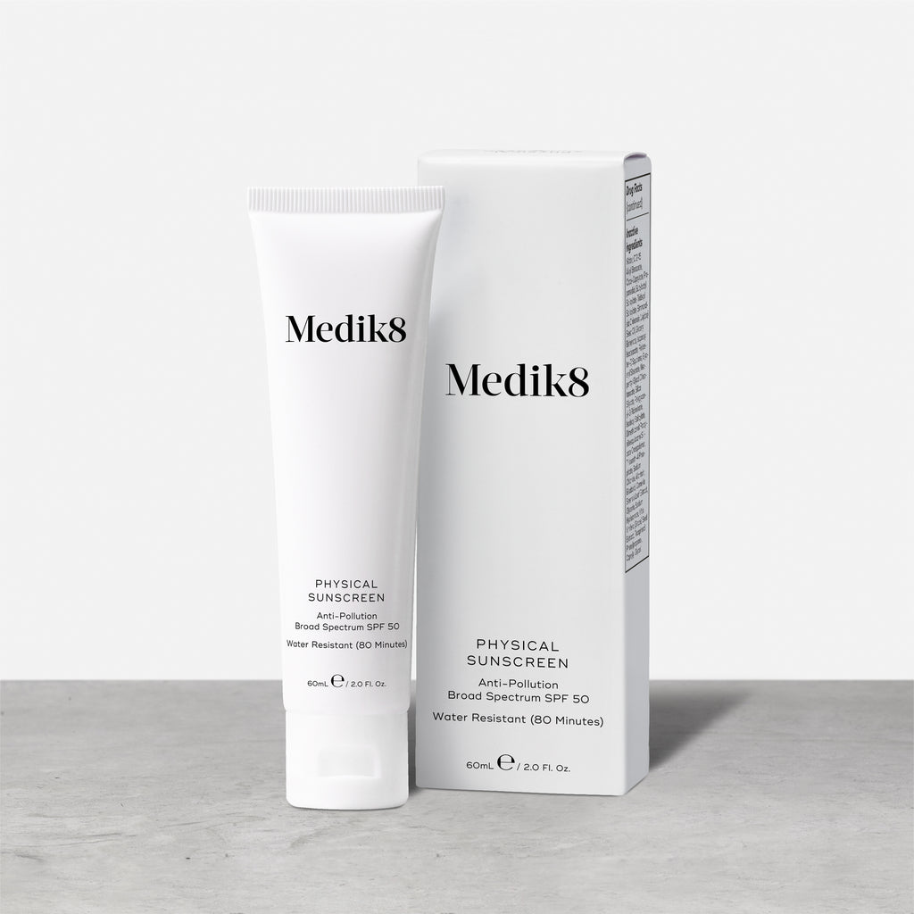 The Medik8 Physical Sunscreen™ tube and box sit on a surface, delivering broad-spectrum SPF 50 UVA/UVB protection with an anti-pollution formula. This 60 mL gem is water-resistant for up to 80 minutes.